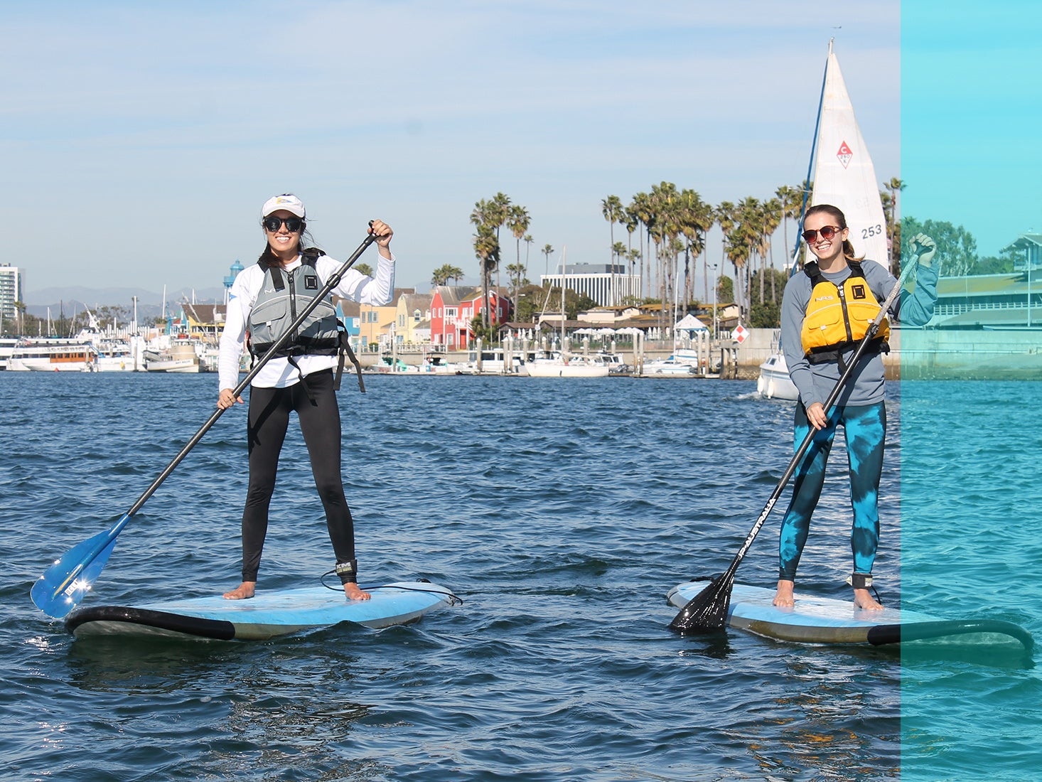 Two students work on their paddle boarding skills at the Marina.